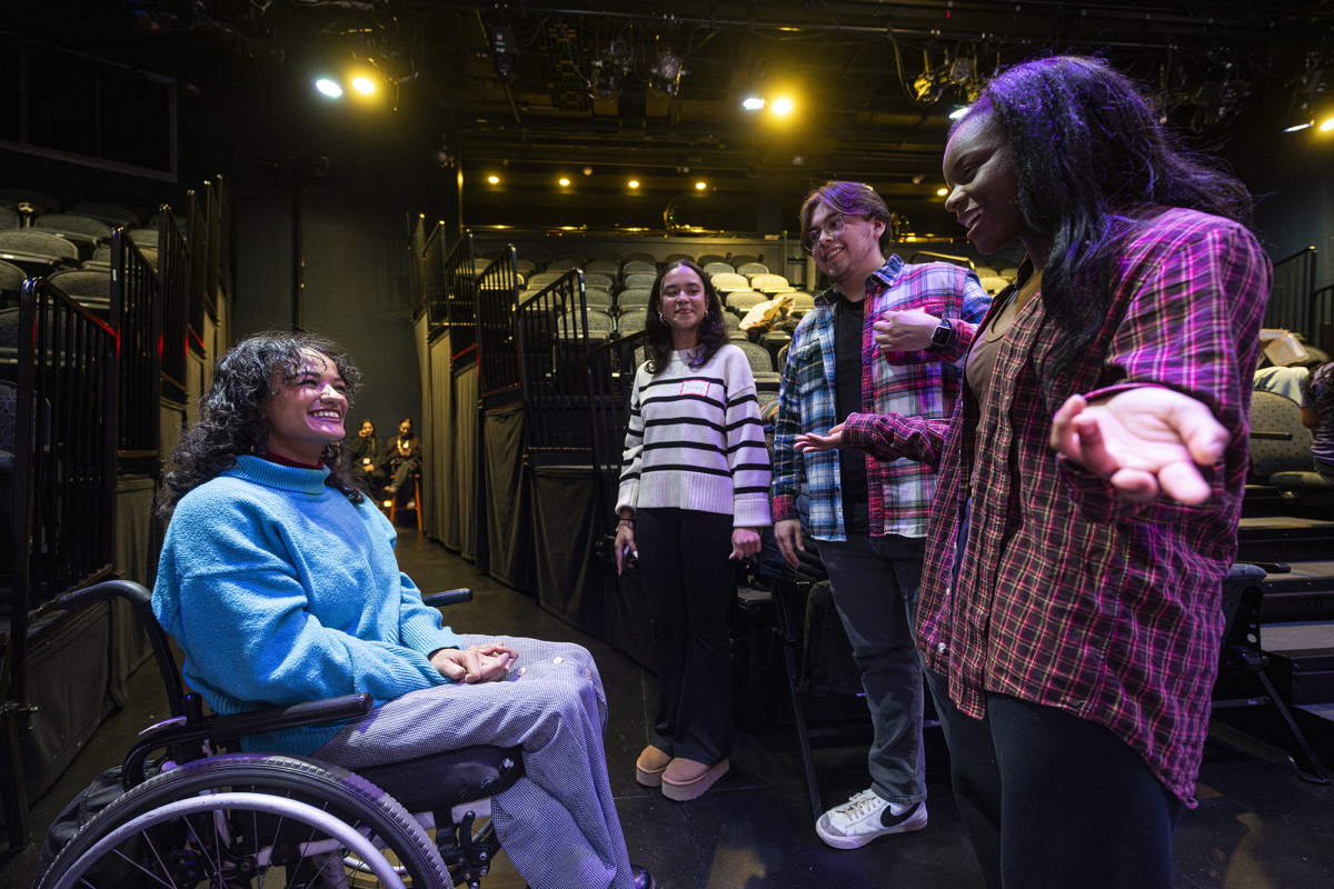 A group of people conversing in a theater