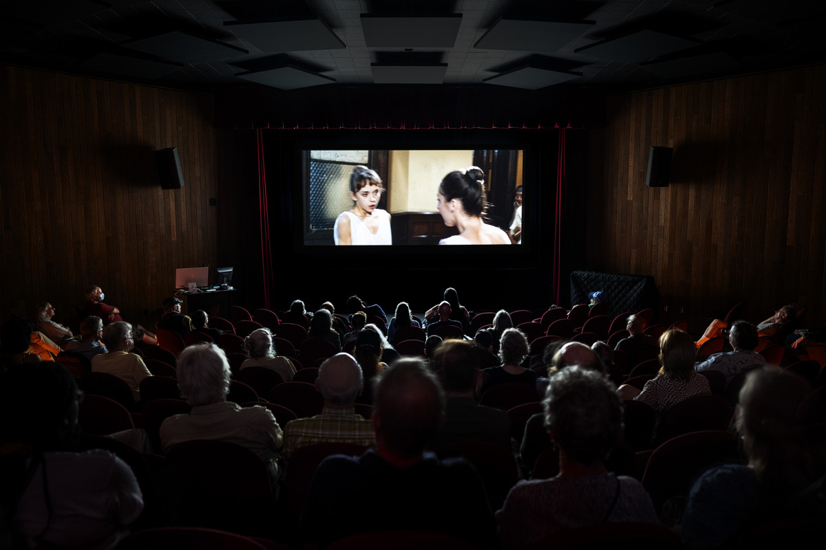 People watching a movie in a darkened theater