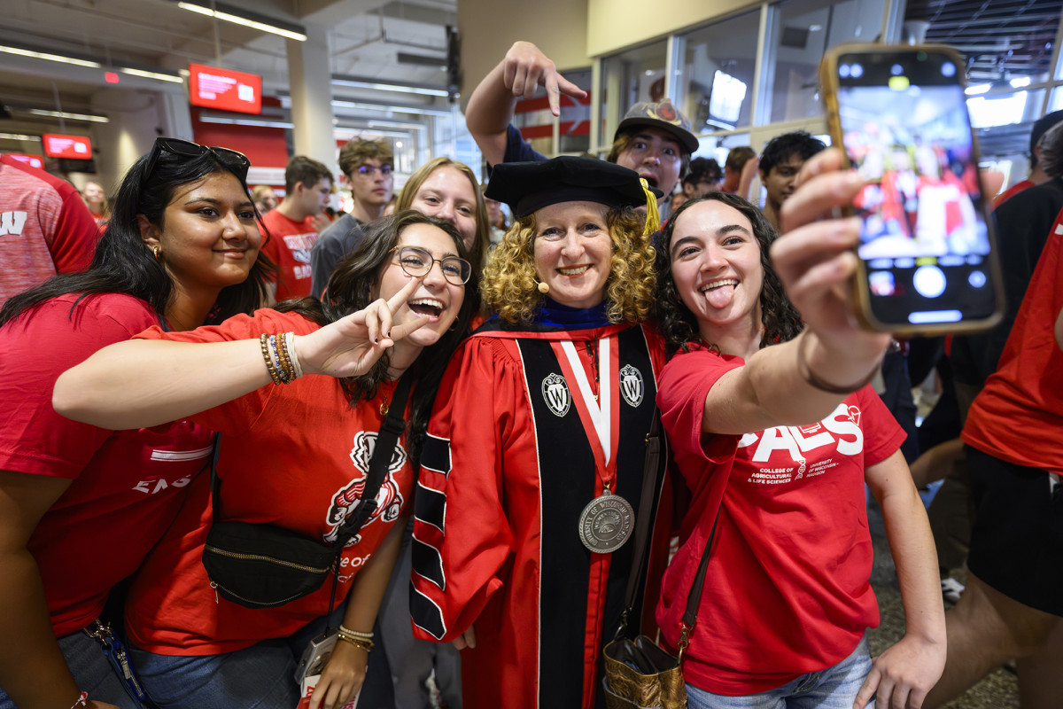 Group of people smiling and taking a selfie