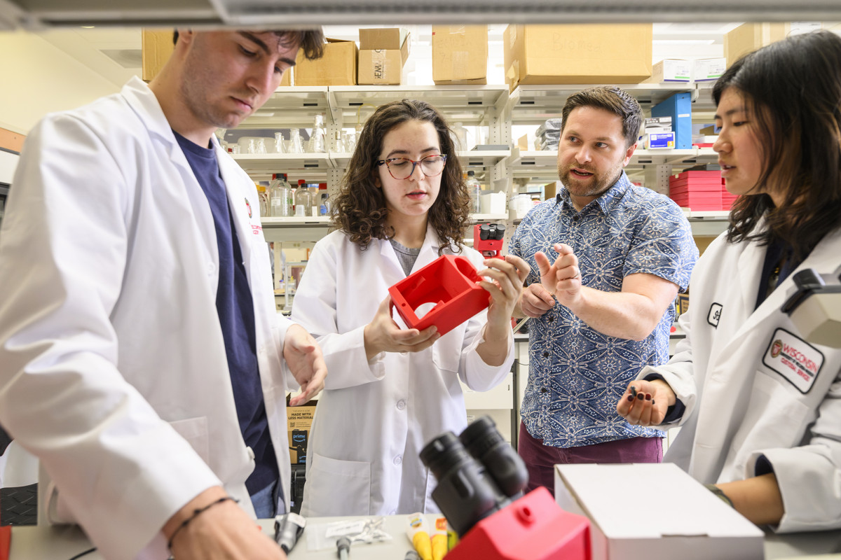 Group of people in lab coats having a discussion
