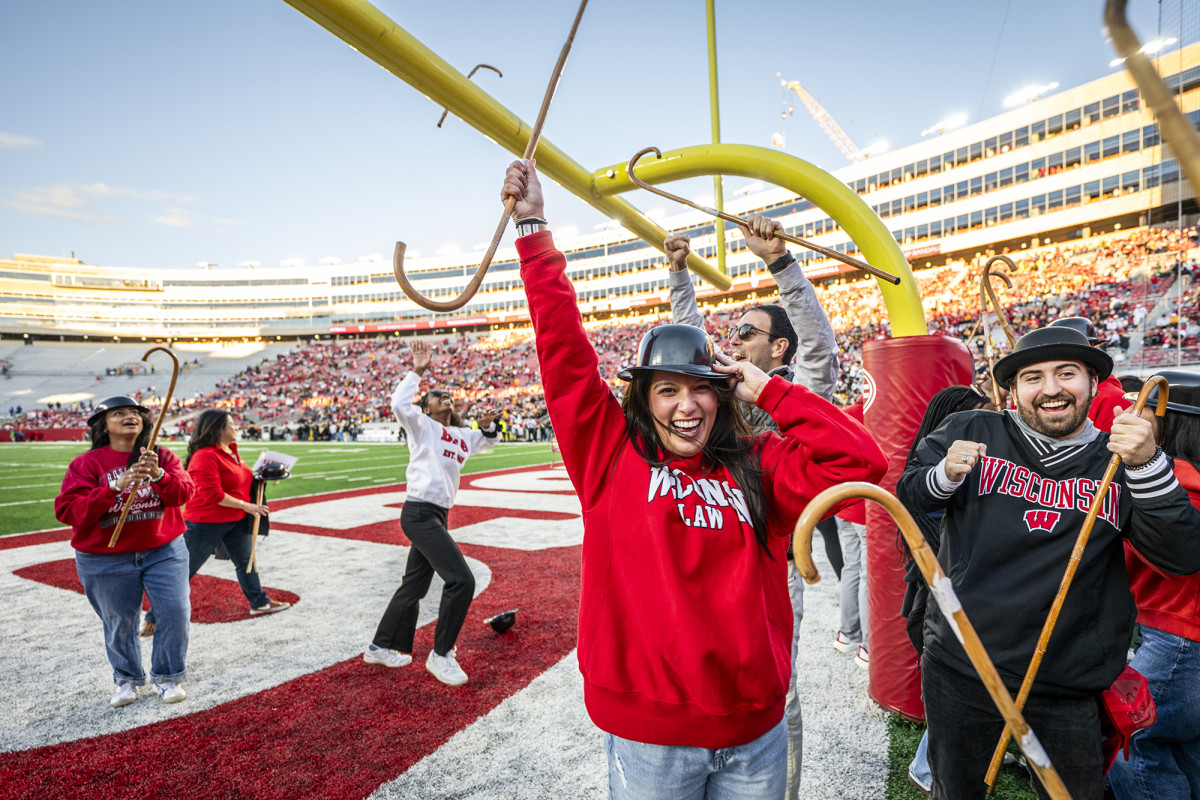 Group of people with canes celebration on a football field