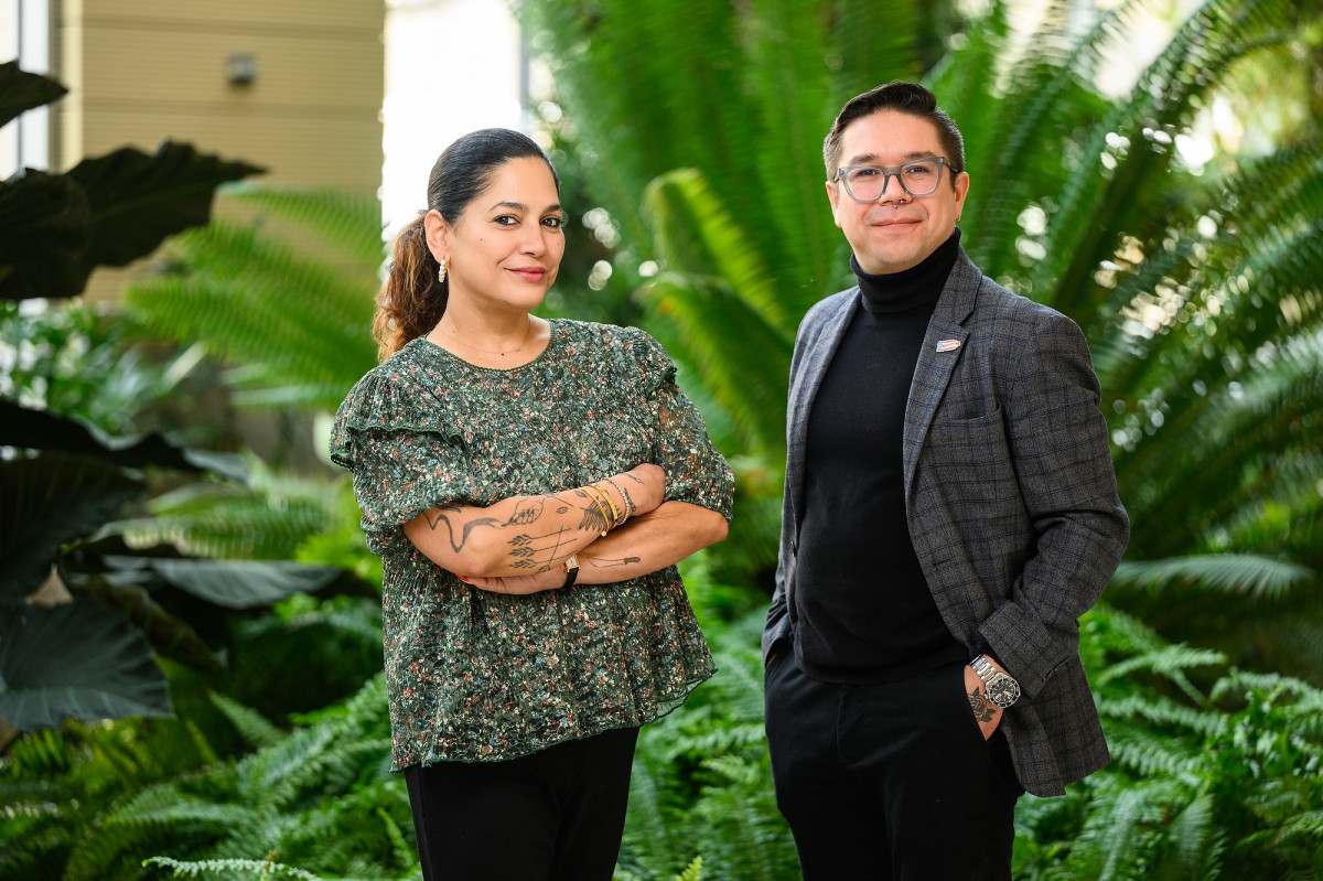 Portrait of Professors Aurora Santiago Ortiz and Jorell Melendez-Badillo at the Wisconsin Institute for Discover, with green plants in the background. 