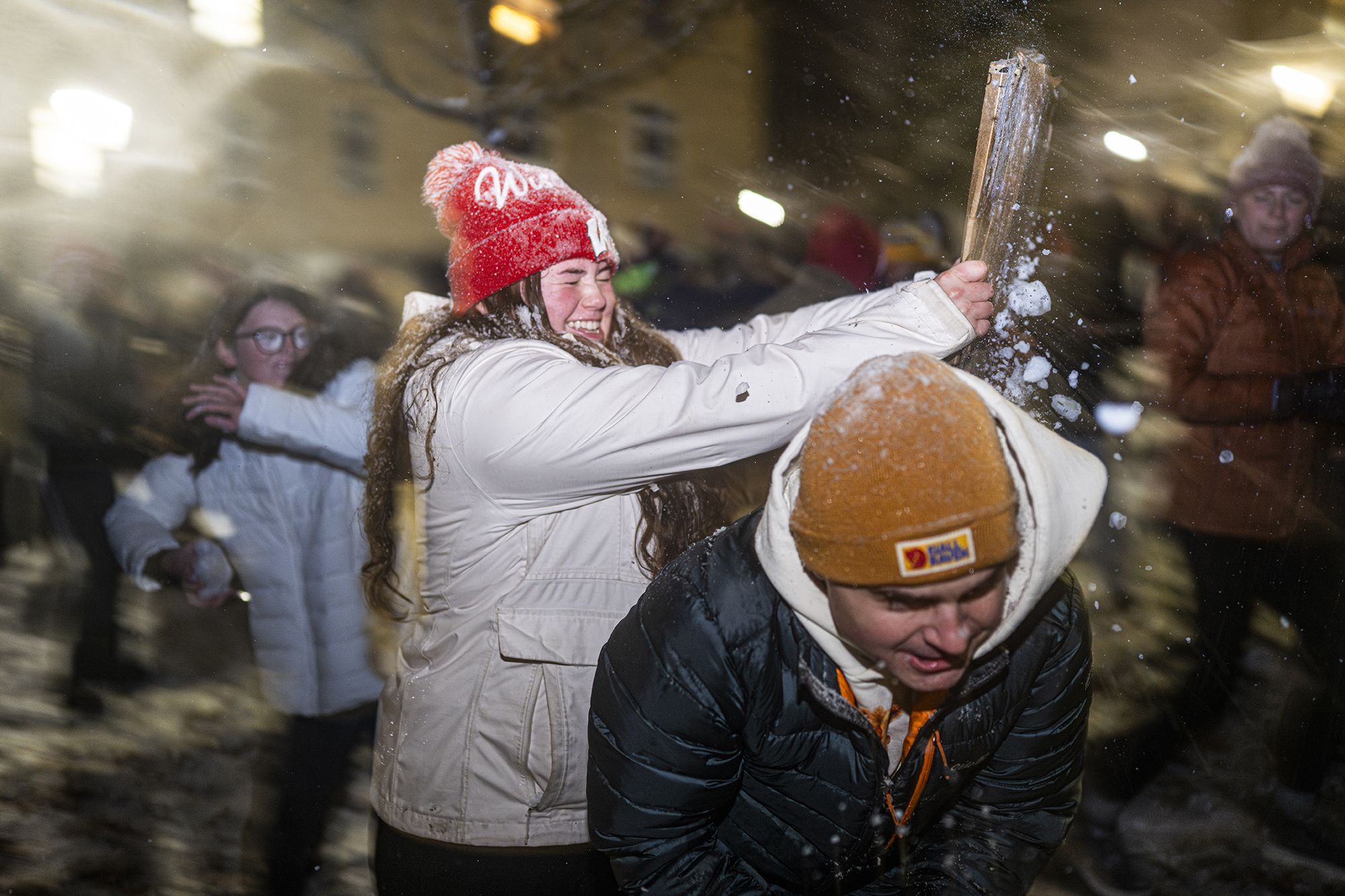 Smiling people in a snowball fight