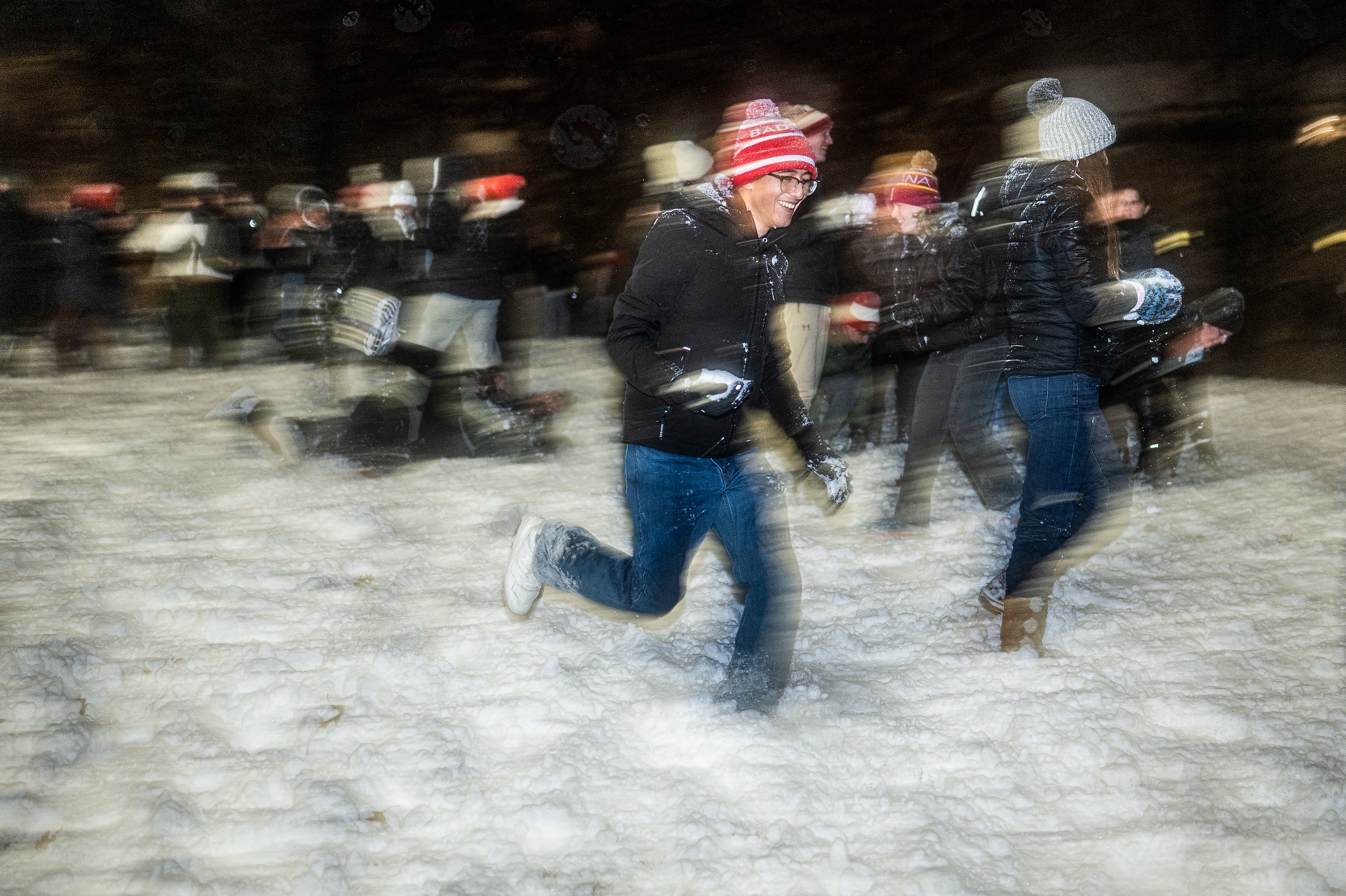 Students running with snowballs