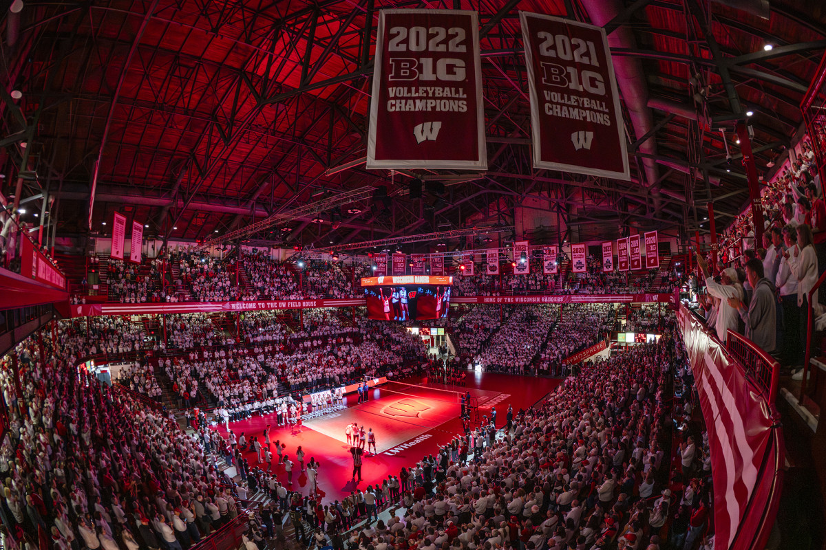 Full stadium lit up in red light for a volleyball game