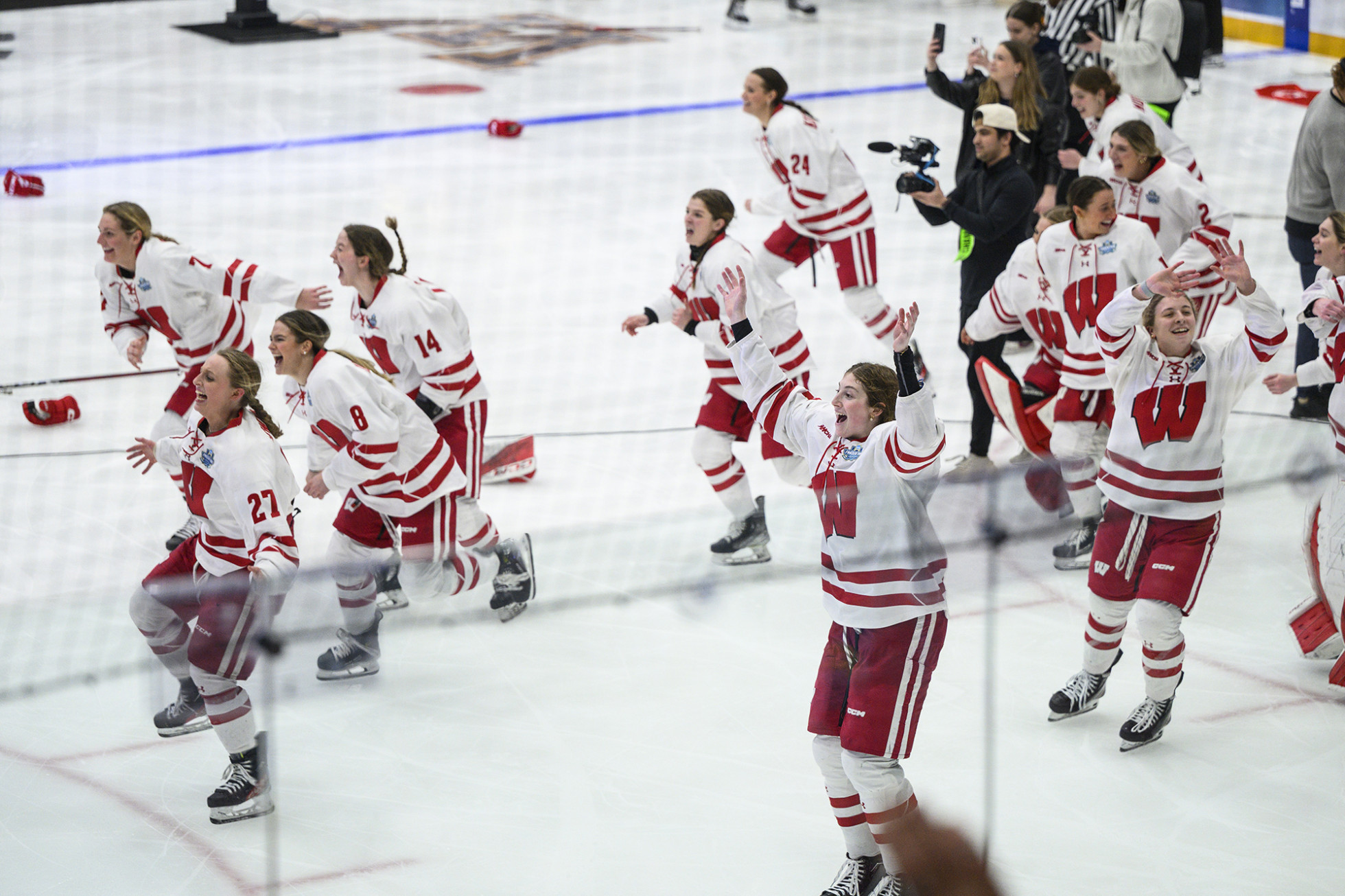 Jubilant hockey players skating out on the ice rink in celebration