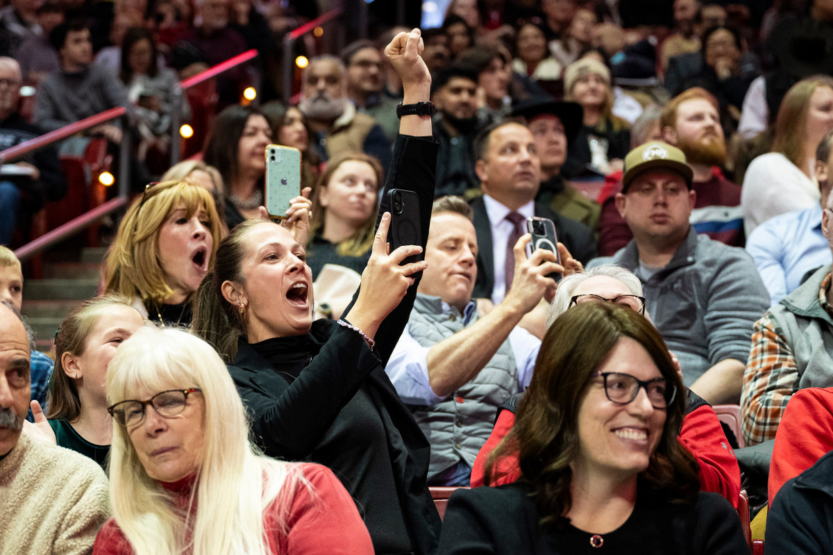 Family and friends cheer from the stands.