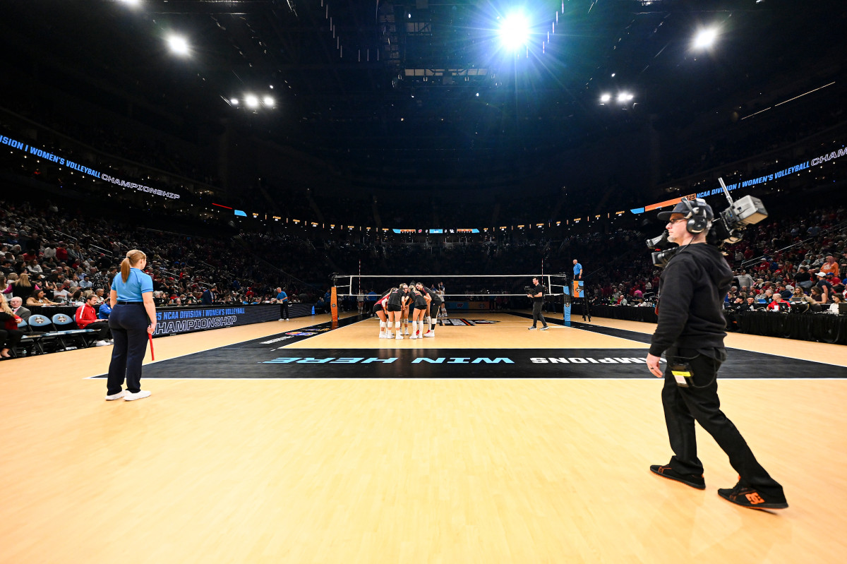 A low angle view of the court and Badger players huddled up.