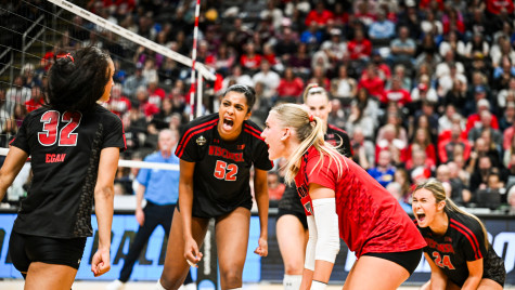 Volleyball player Carter Booth yells and celebrates with her teammates.