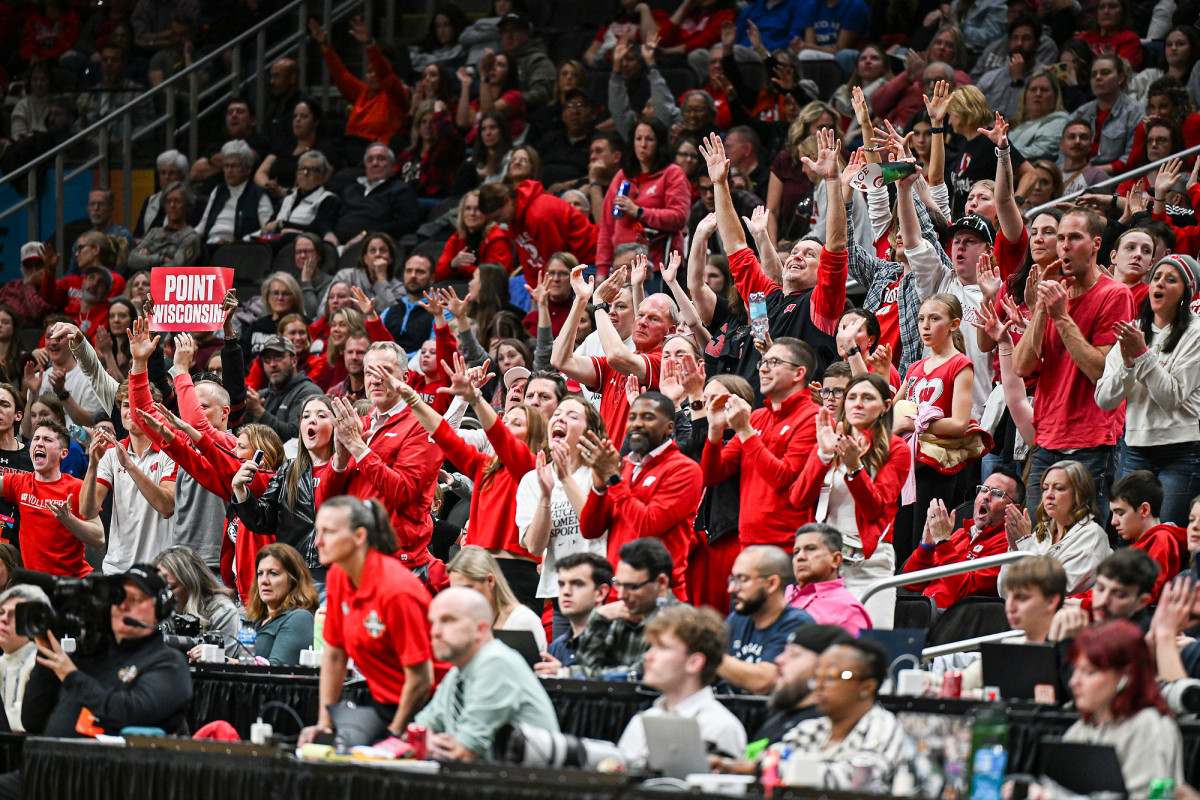 The Badger fan section stands and cheers during the match. 