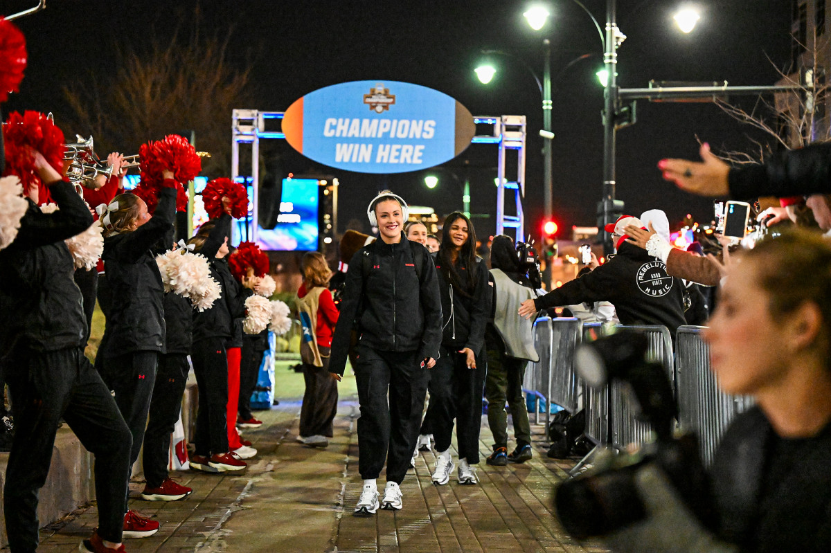 Members of the UW volleyball team are greeted by Badger fans and the Spirit Squad outside the T-Mobile Center. 