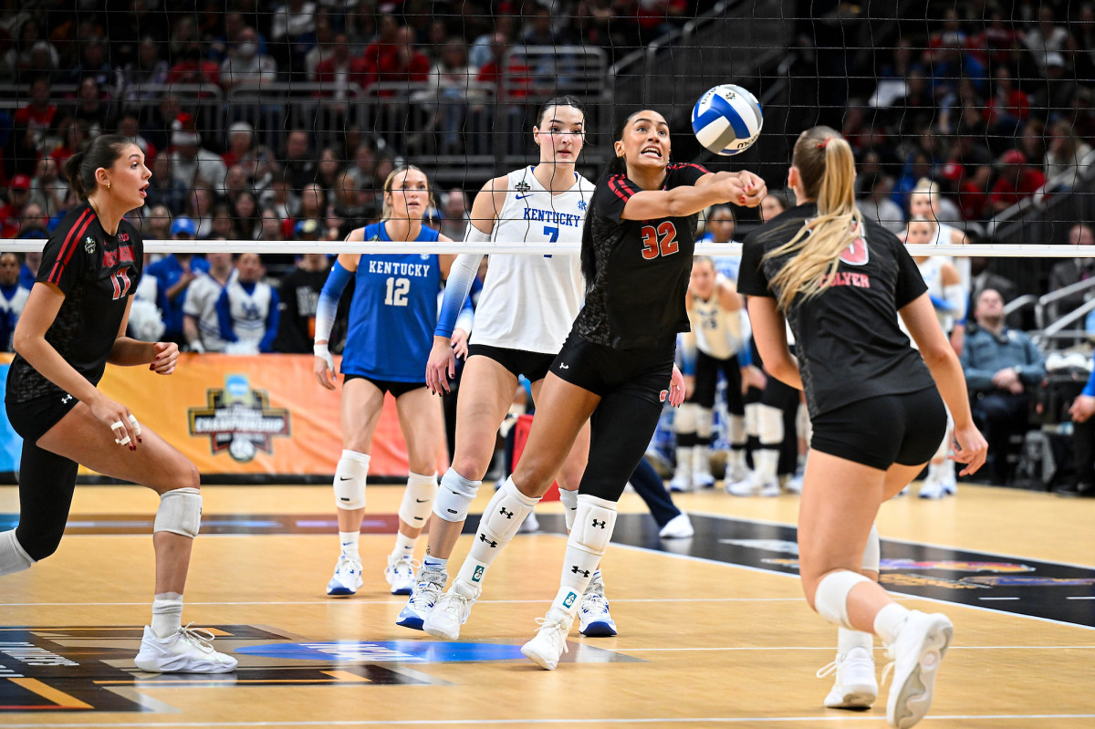 Grace Egan extends her arms to bump the volleyball. 