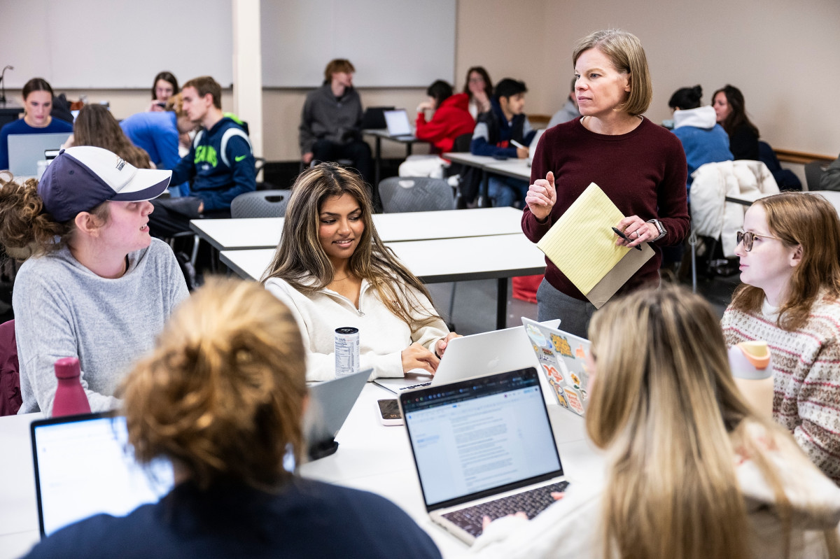 Wichowsky stands next to a table of students.