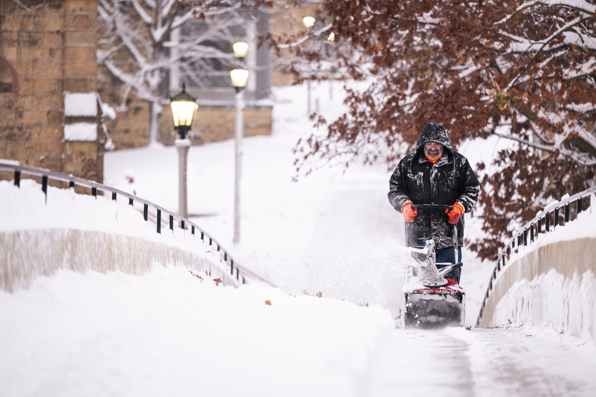 A person using a snowblower