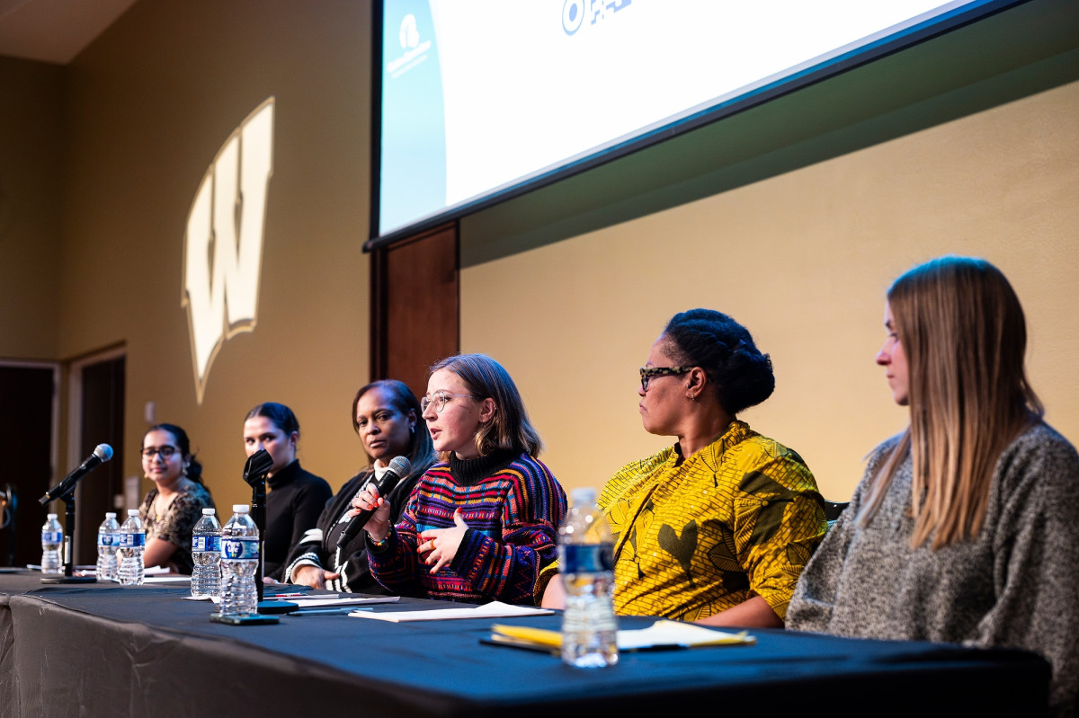 Panelists who at the community dinner event sit at a head table in front of the room and speak to the audience.
