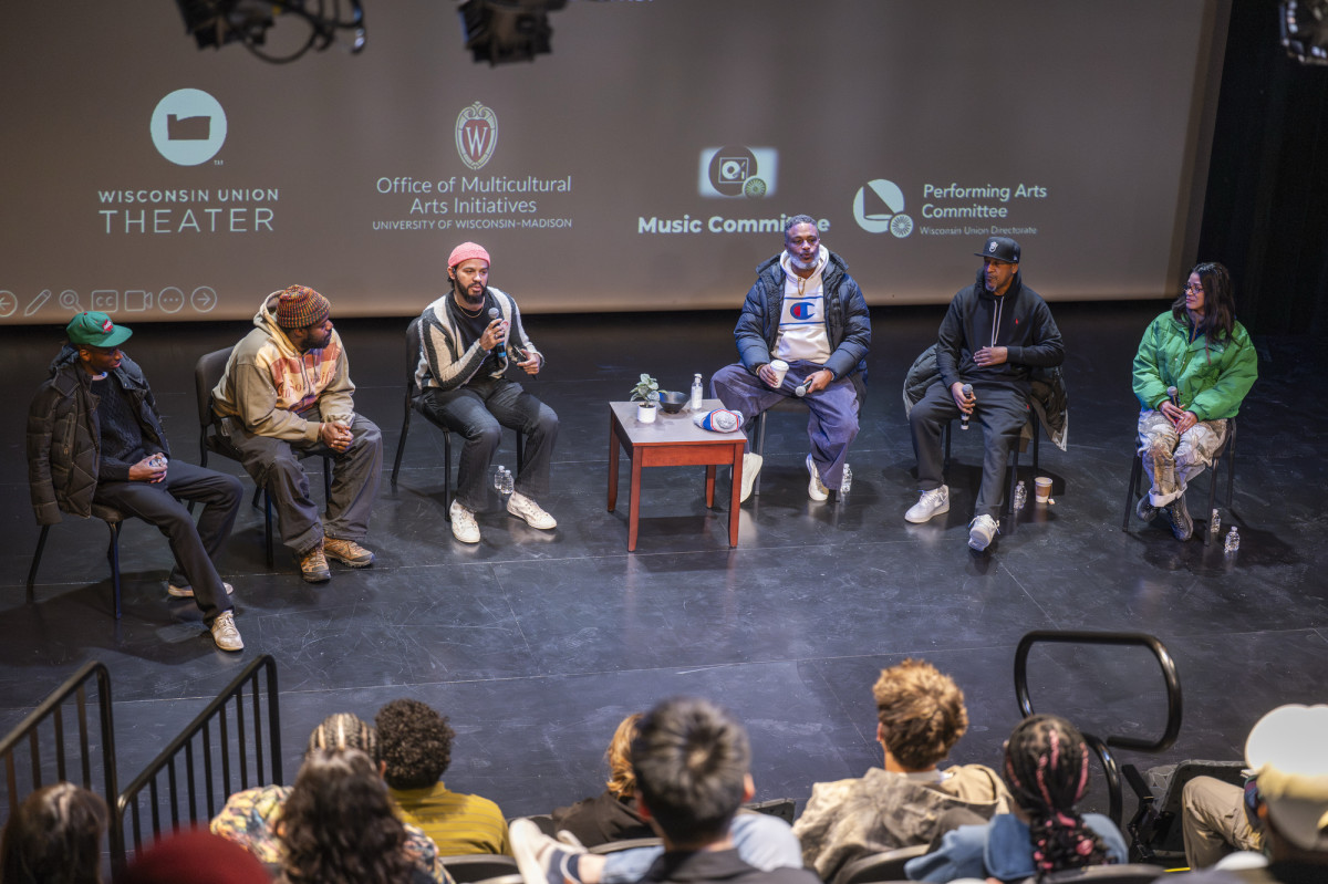 Members of the Digable Planets and MIKE sit on stage and speak with the audience.