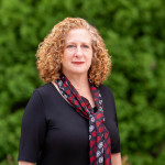 Portrait of Chancellor Jennifer L. Mnookin standing in front of a green background.