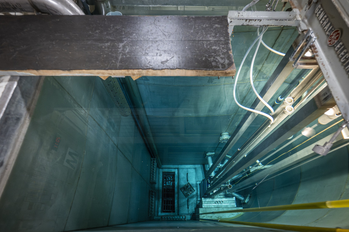 A view down the water-filled shaft of a nuclear reactor.