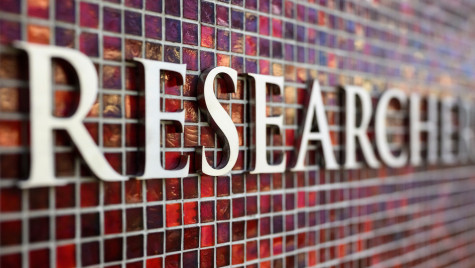 Silver lettering spelling the words research appears against a red mosaic tile background.