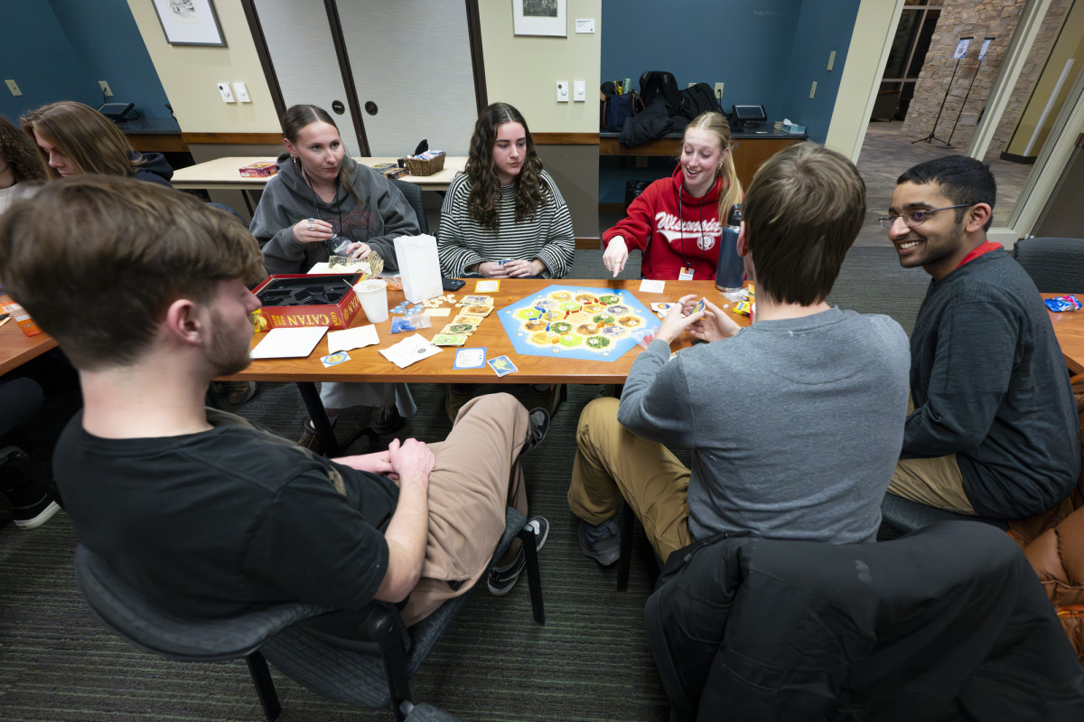 People sit around a table playing games.