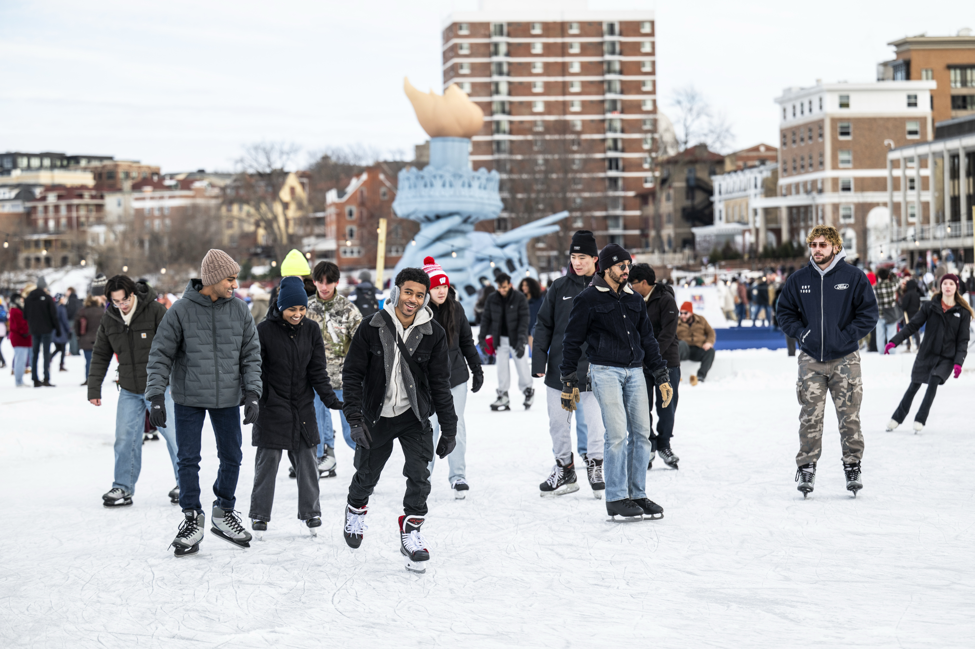 People ice skating on frozen Lake Mendota
