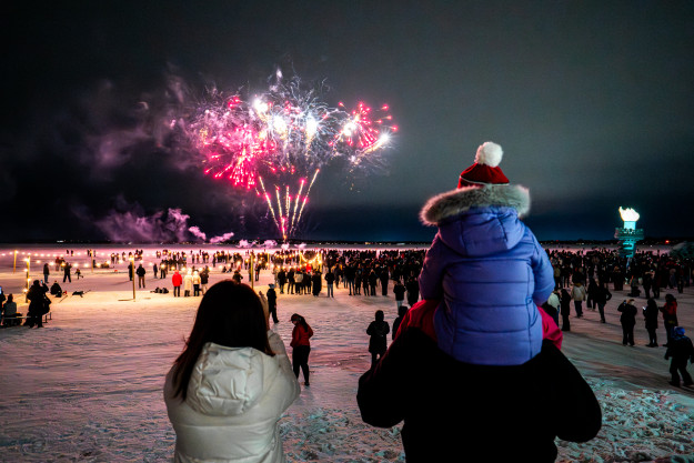 Fireworks light up the sky as spectators gather on the frozen lake during the Wisconsin Union’s Winter Festival at the University of Wisconsin–Madison on Feb. 7, 2026. The event is part of the annual Wisconsin Union Winter Carnival which runs Feb. 5-7, 2026 and included ice fishing, Lady Liberty, fireworks, and a freestyle snowboard and ski show.