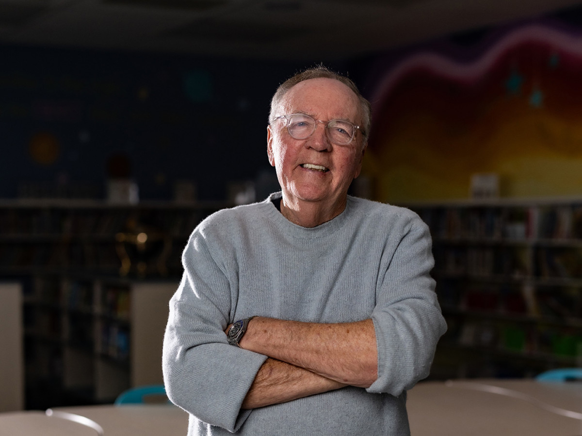 James Patterson smiles in a school classroom
