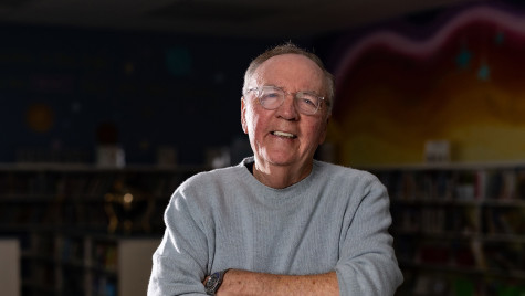 James Patterson smiles in a school classroom