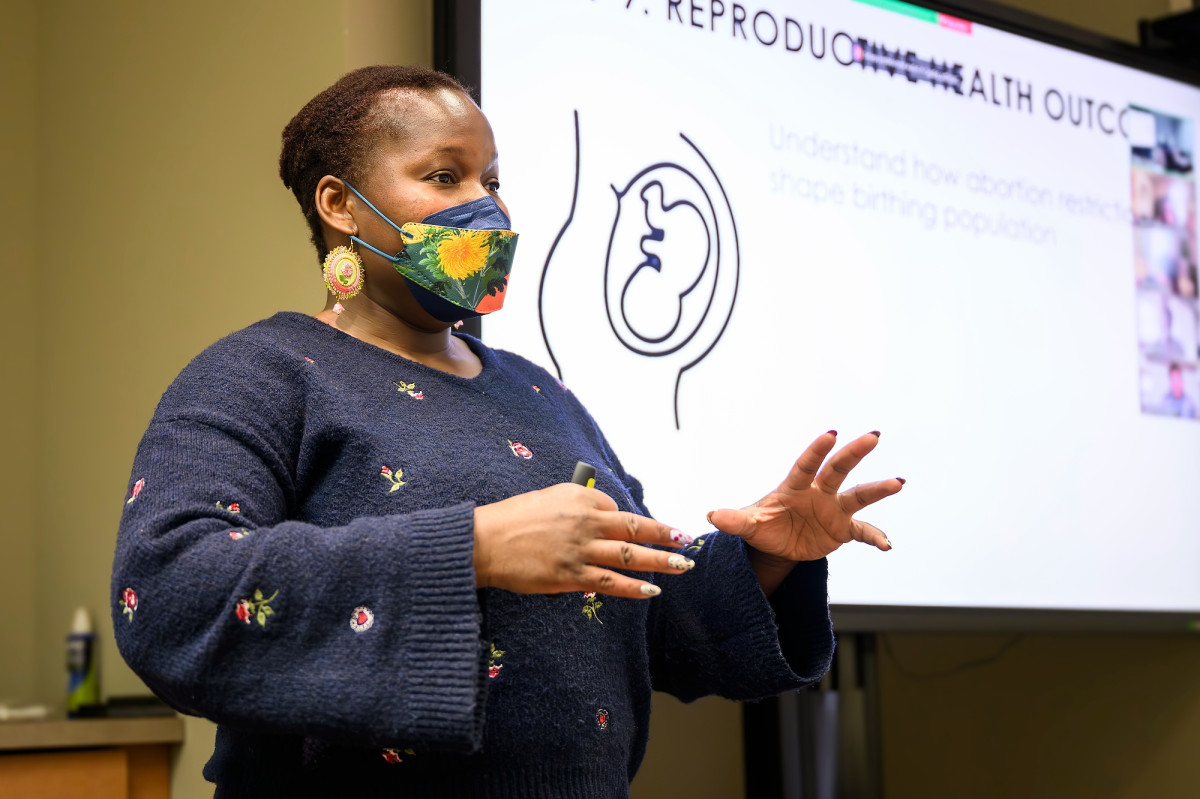 Tiffany Green stands at the head of a classroom speaking to her students.