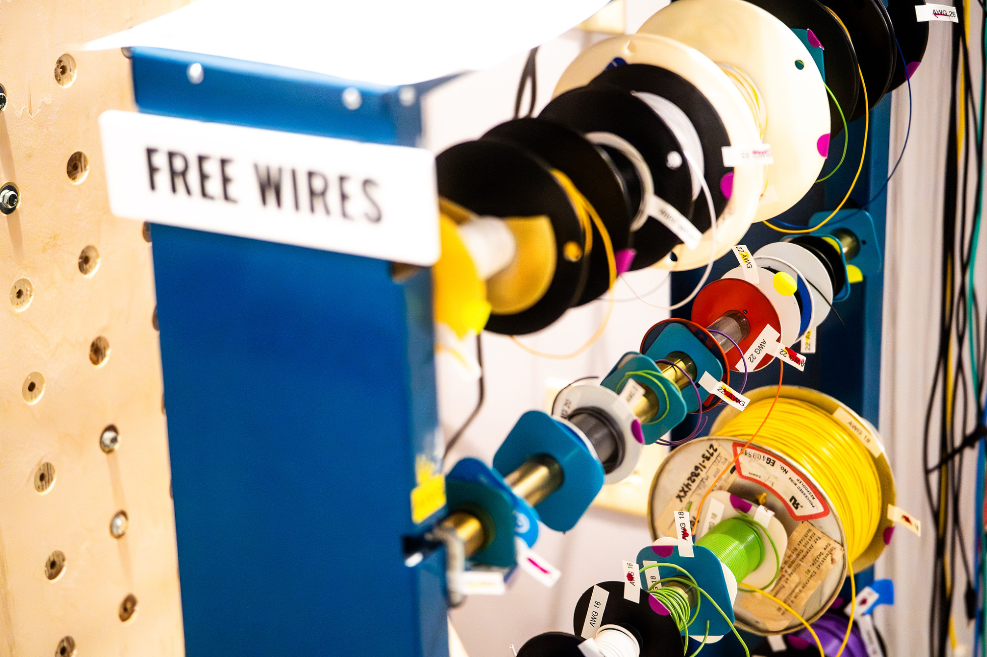 A blue rack of electrical wires with a sign that reads: free wires.