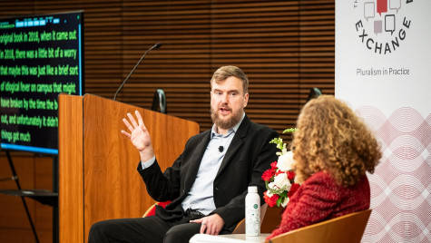 Greg Lukianoff and Chancellor Mnookin sit on stage during a conversation in front of a large audience.