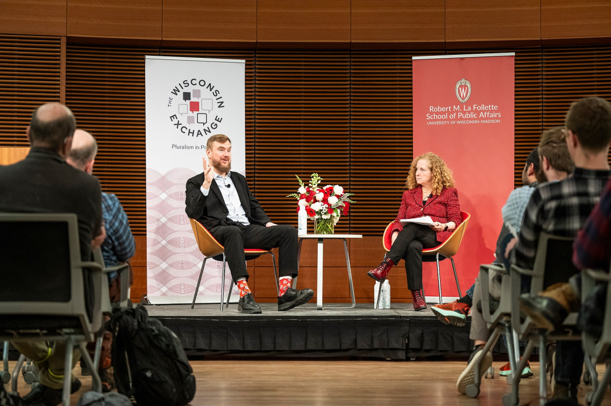 Greg Lukianoff and Chancellor Mnookin sit on stage during a conversation in front of a large audience.