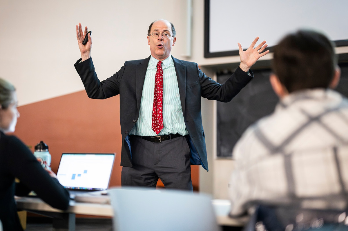 Jonathan Martin stands at the head of a classroom enthusiastically explaining a weather concept to his class.