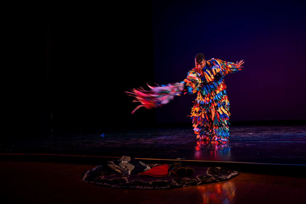 Stacy Letrice wears a costume of bright fringed fabric and while dancing on stage.