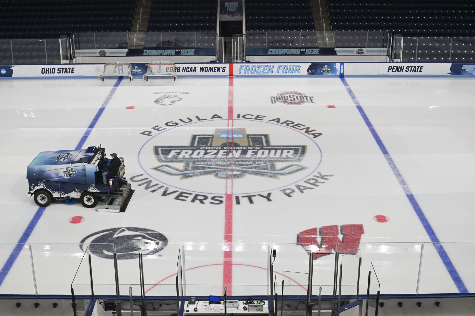 A Zamboni rides over an ice hockey rink that sports the 2026 NCAA Frozen Four logo.