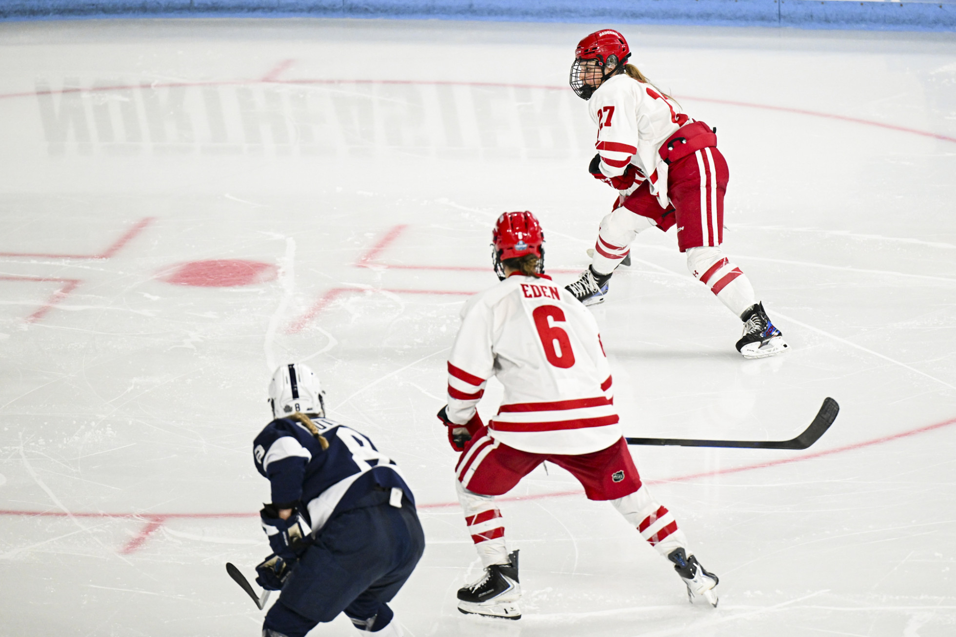 Surrounded by Nittany Lion players, Badger Kirsten Simms lines up to take a shot at the goal. 