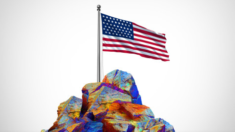A conceptual rendering of rare earth elements in a rock pile, with a U.S. flag on top of it.