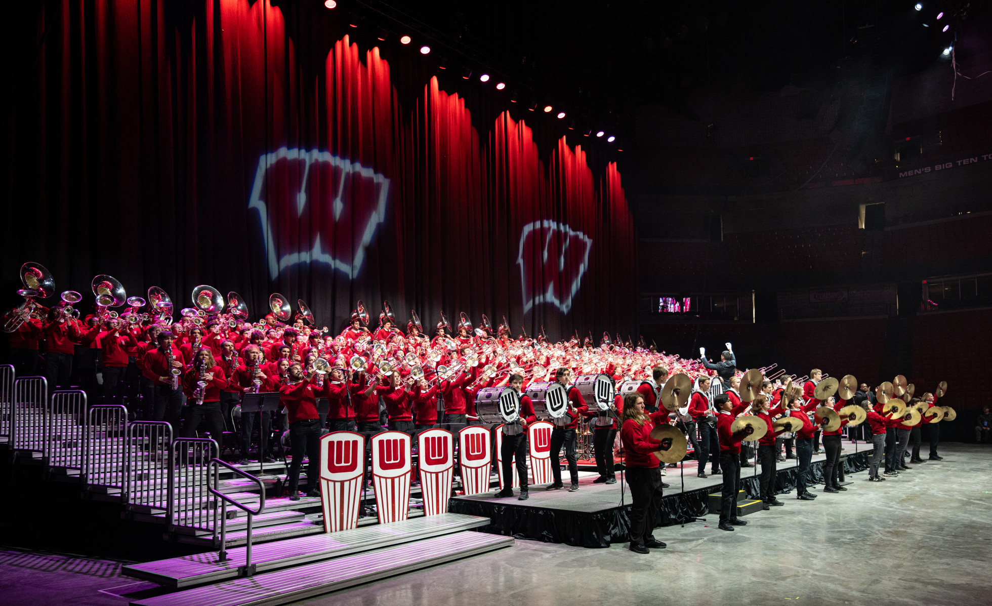 The full UW Marching Band performing on stage.