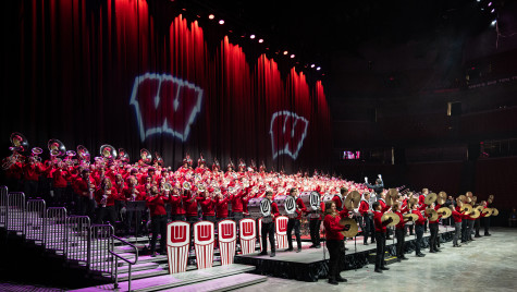 The full UW Marching Band performing on stage.