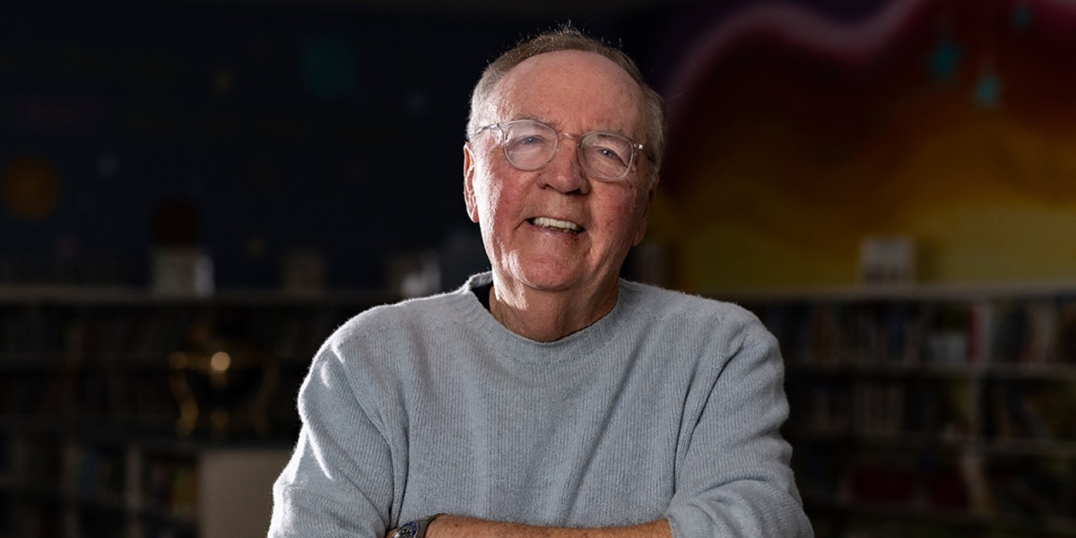James Patterson smiles in a school classroom