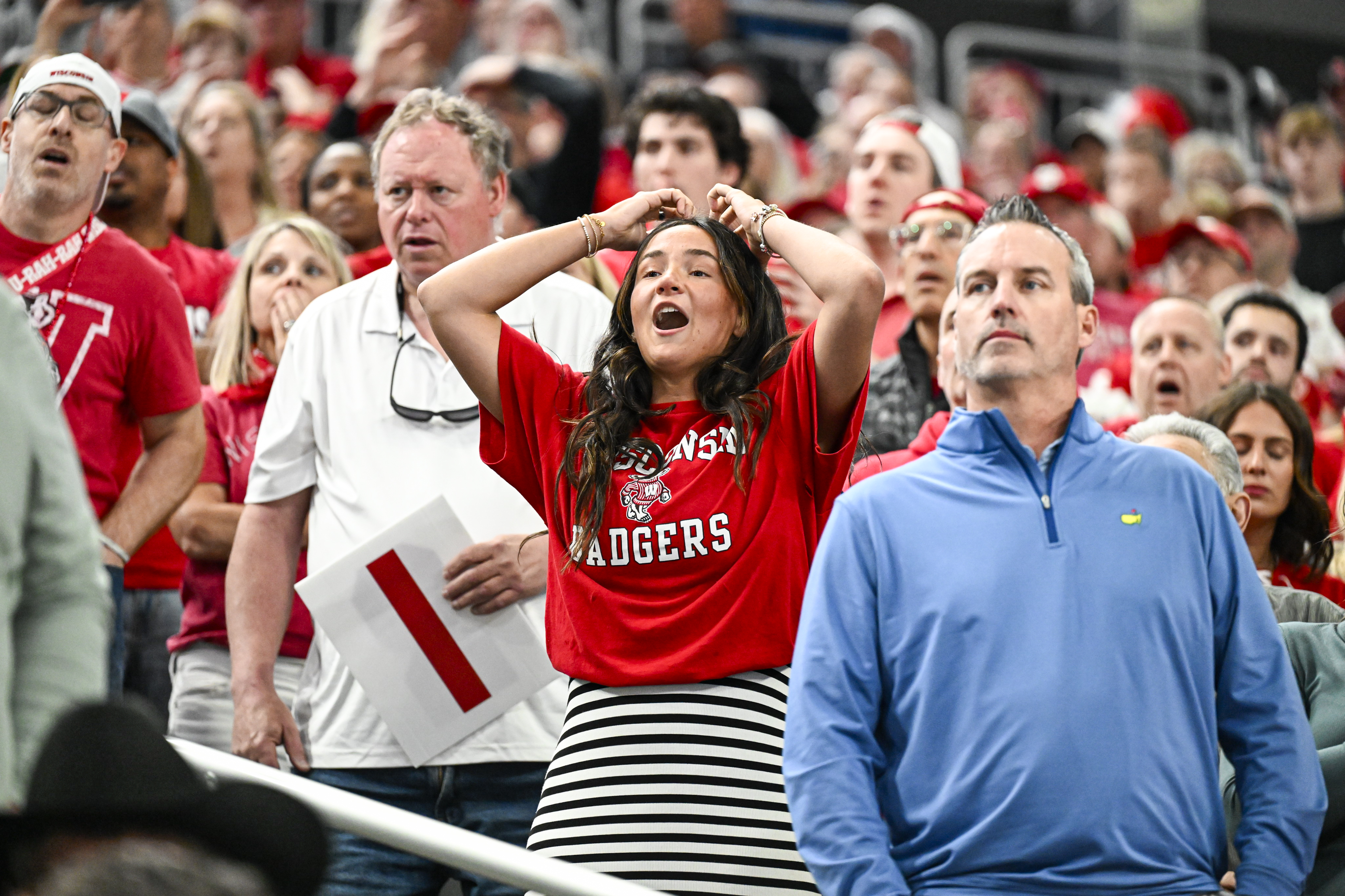 In the stands, Badger fans show surprise and disappointment on their faces.