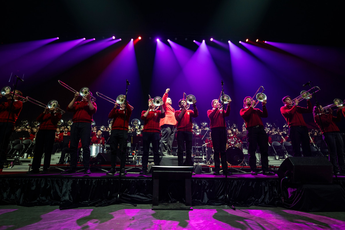 Members of the trombone section line up on stage for a solo.