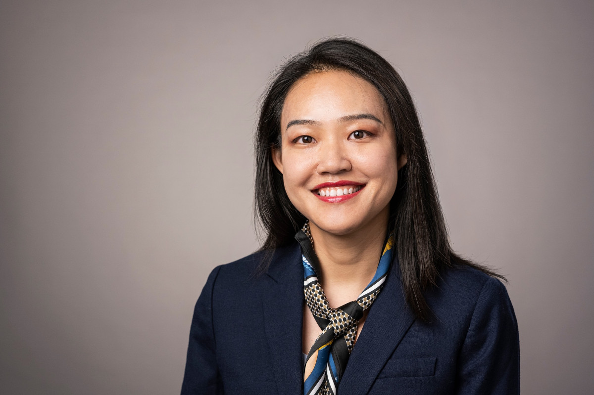 Portrait of Tianlu Zhang smiling, wearing a scarf and blazer