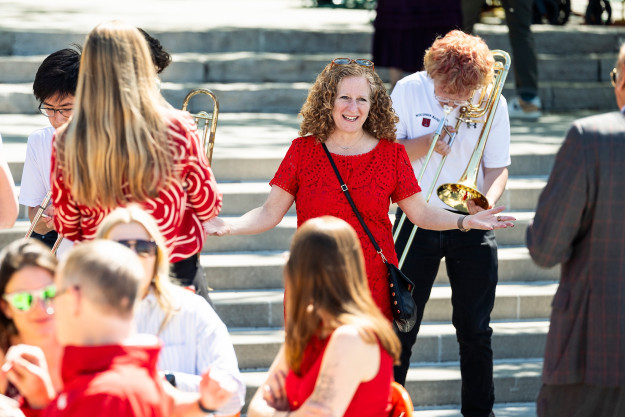 With arms outstretched, Mnookin acknowledges the crowd gathered on the Memorial Union Terrace.