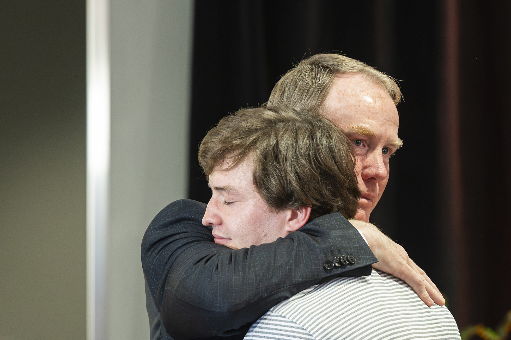 A close-up of Shawn Eichorst hugging his son. 