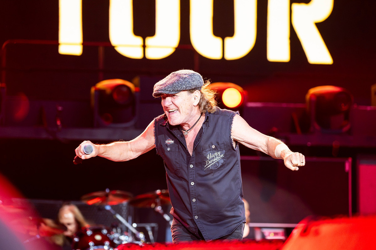 Wearing a Harley Davidson shirt and tweed cap, AC/DC lead singer, Brian Johnson performs