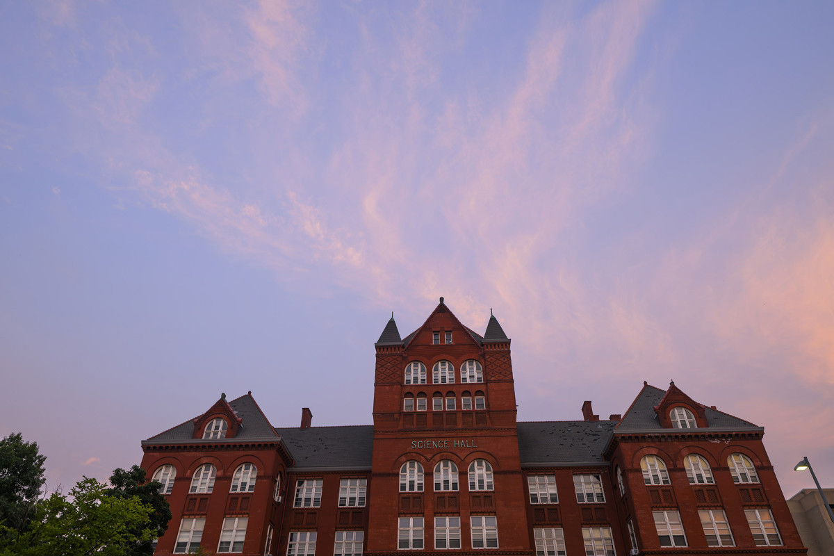 Science hall against a pink and blue sky during sunrise