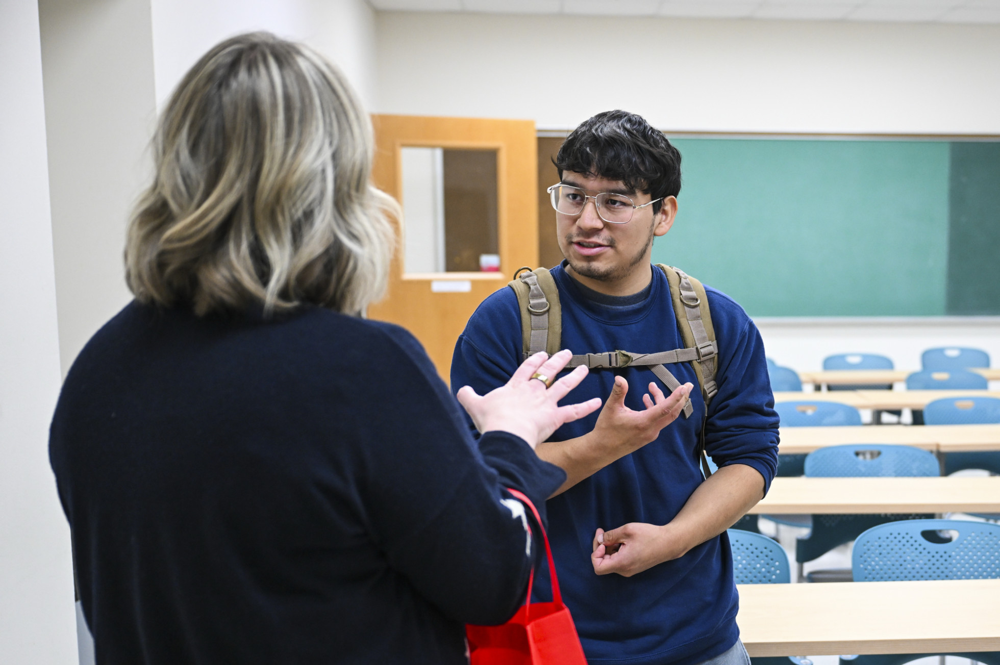 Student Brian Bernal talks with Eimear Robertson in a classroom. 