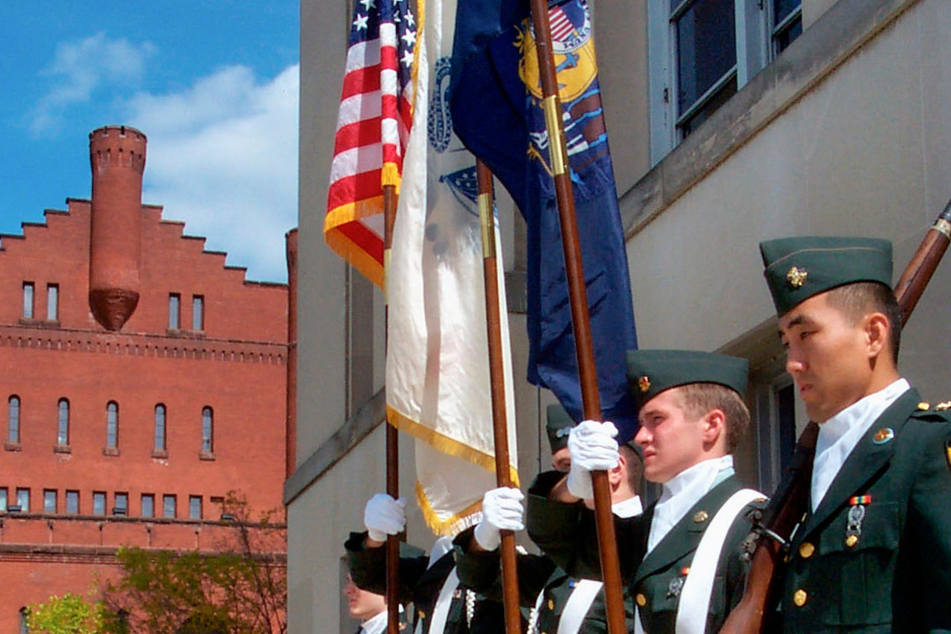ROTC Color Guard members stand at attention and hold the American and Wisconsin flags. 
