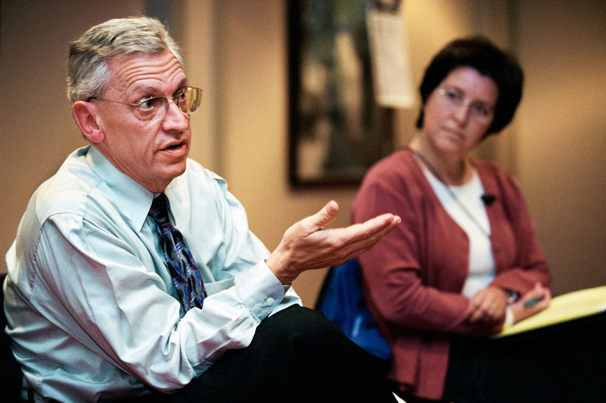 Chancellor John Wiley speaks with his hand motioned out, next to Dean of Students Alicia Chavez.